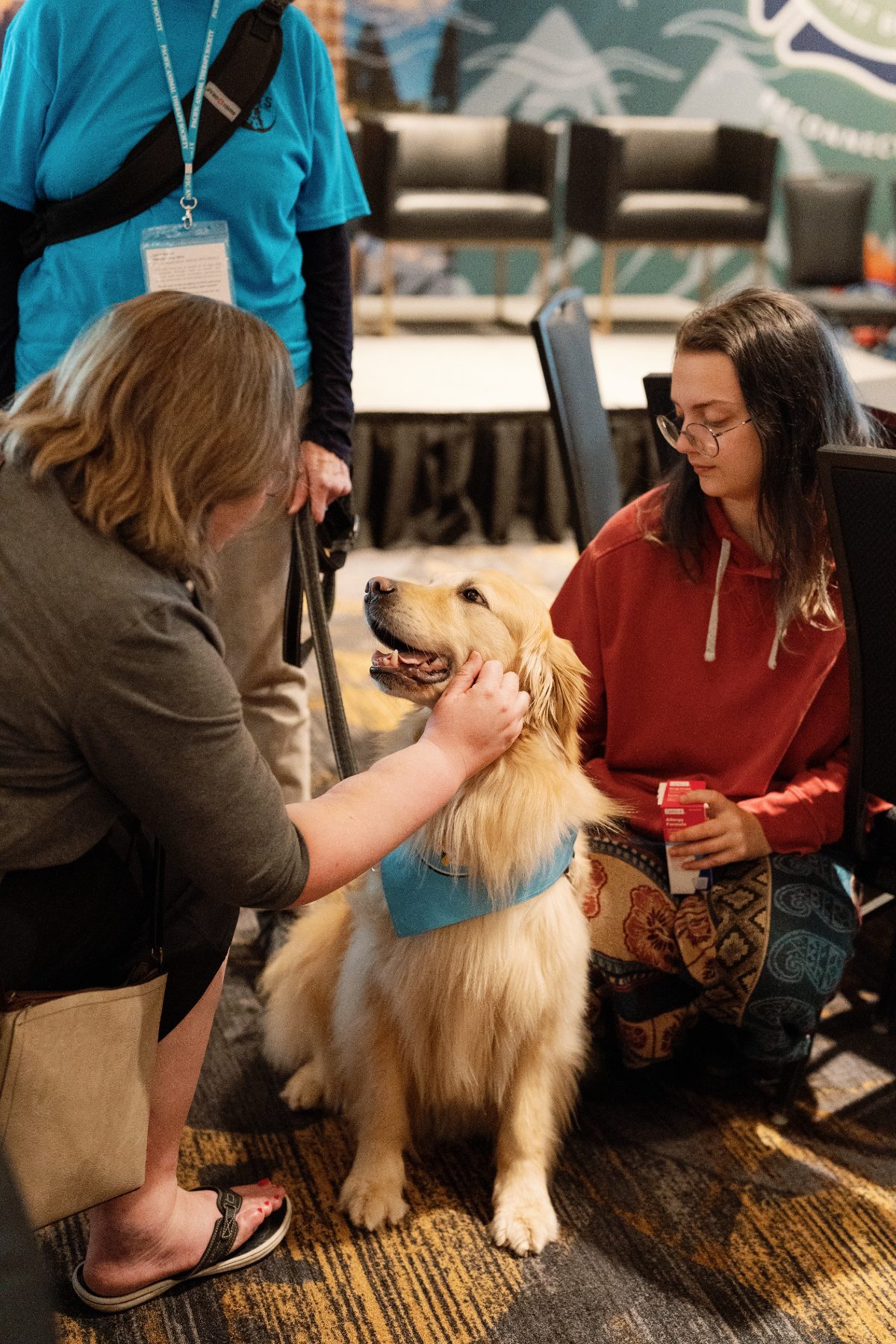 A therapy dog visiting attendees at the 2025 Forum