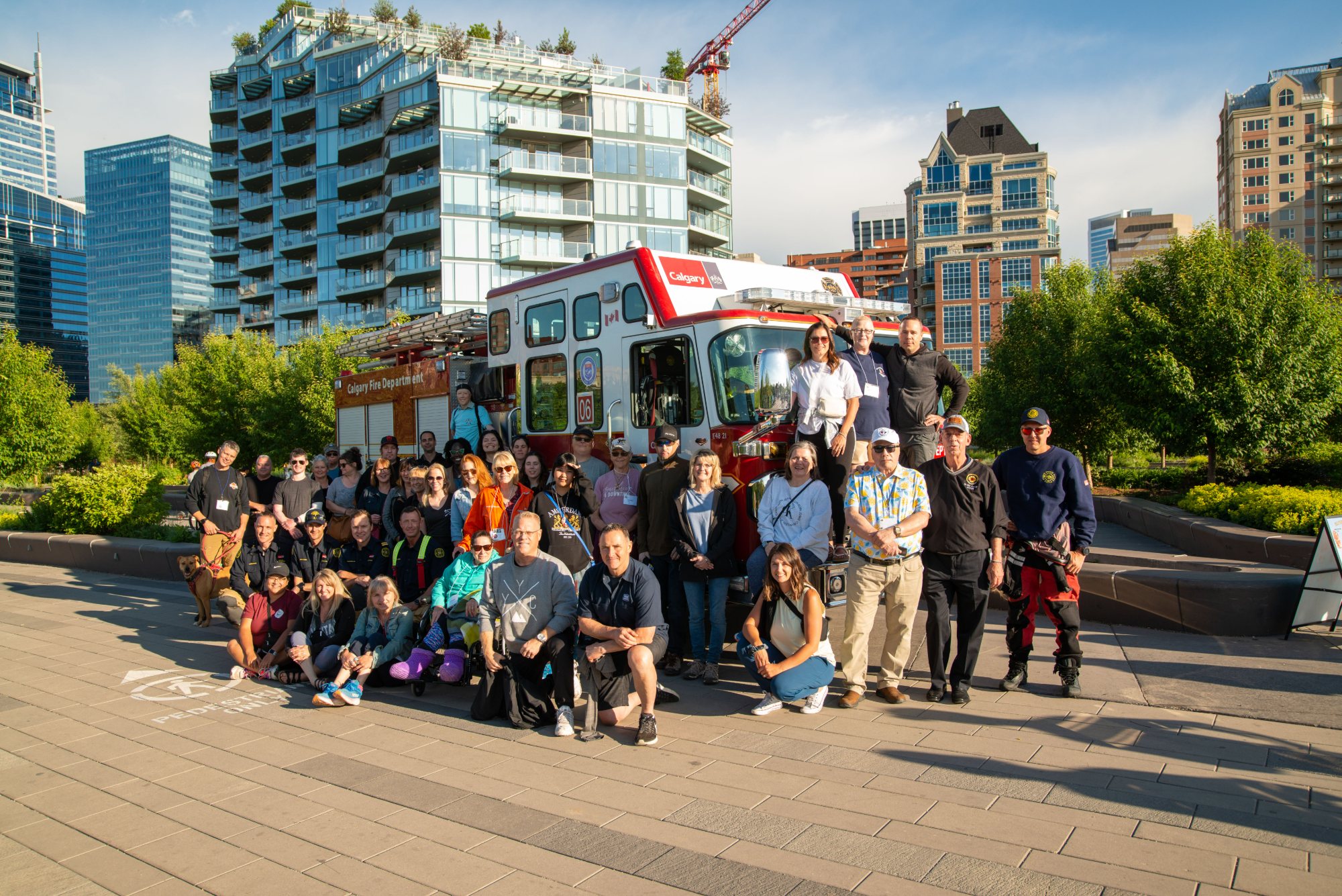 More than fifty survivors, families and firefighters together in a Calgary park at the 2023 National Forum